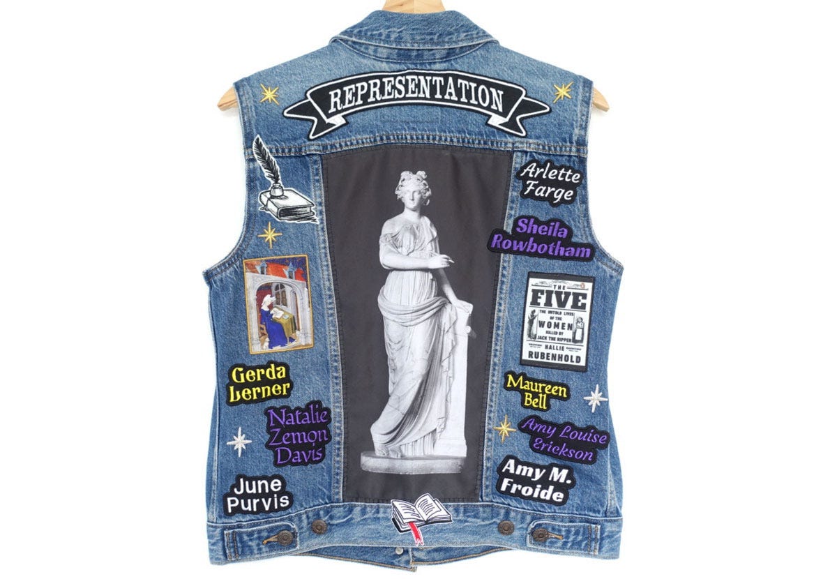 A sleeveless denim jacket decorated with embroidered patches