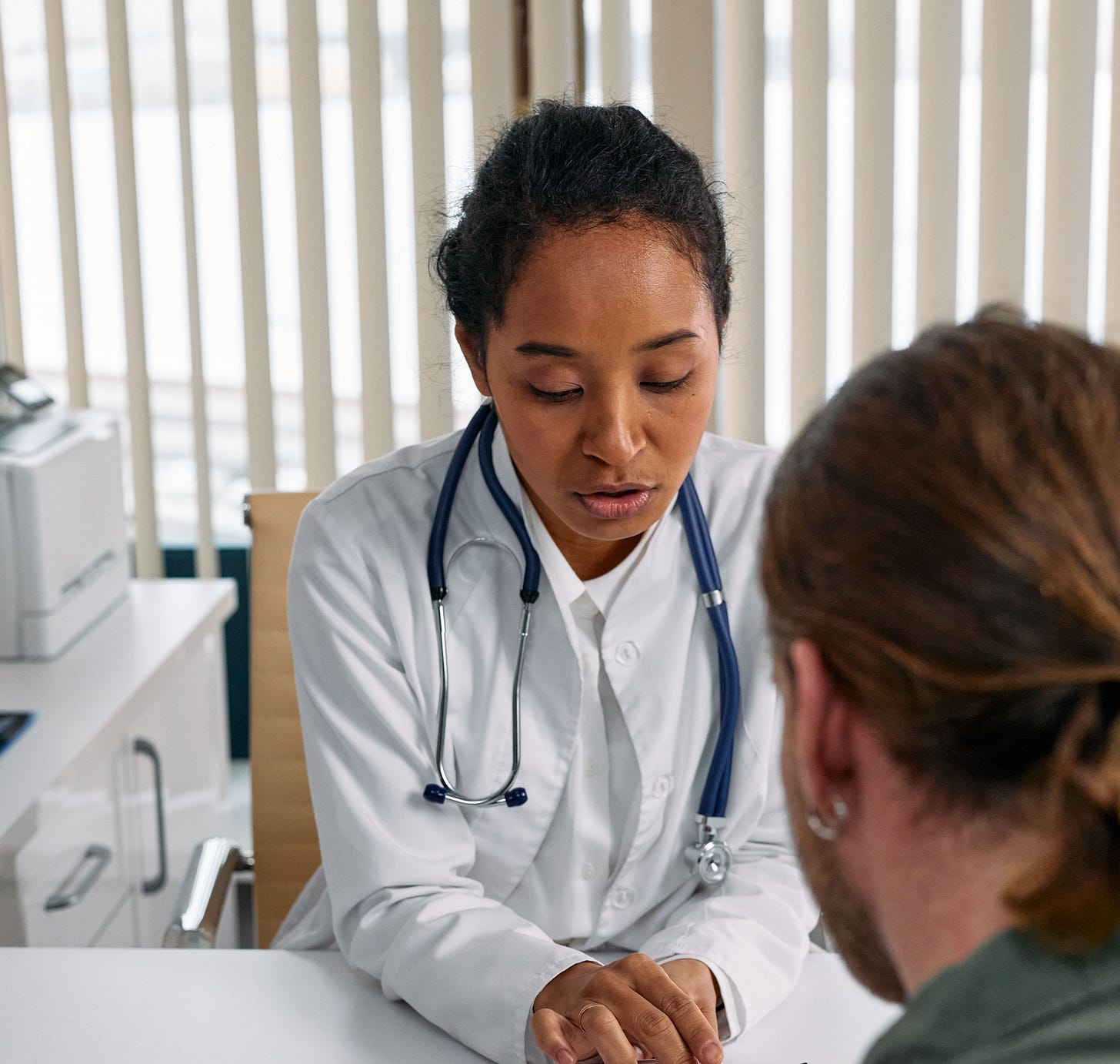 Physician speaking with a patient