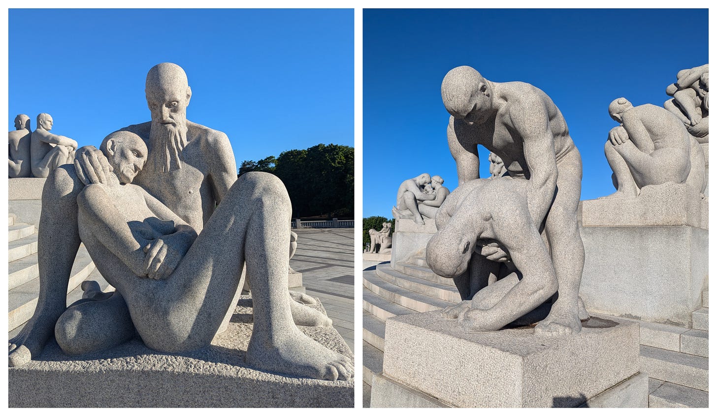 Granite sculpture on left showing man cradling dead wife, sculpture on right showing one man trying to lift up another. 
