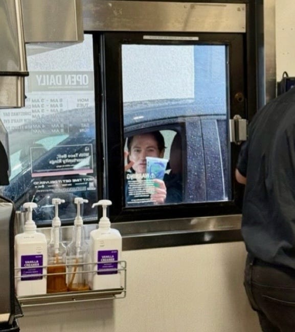 A closer zoom of the man in the drive-thru window