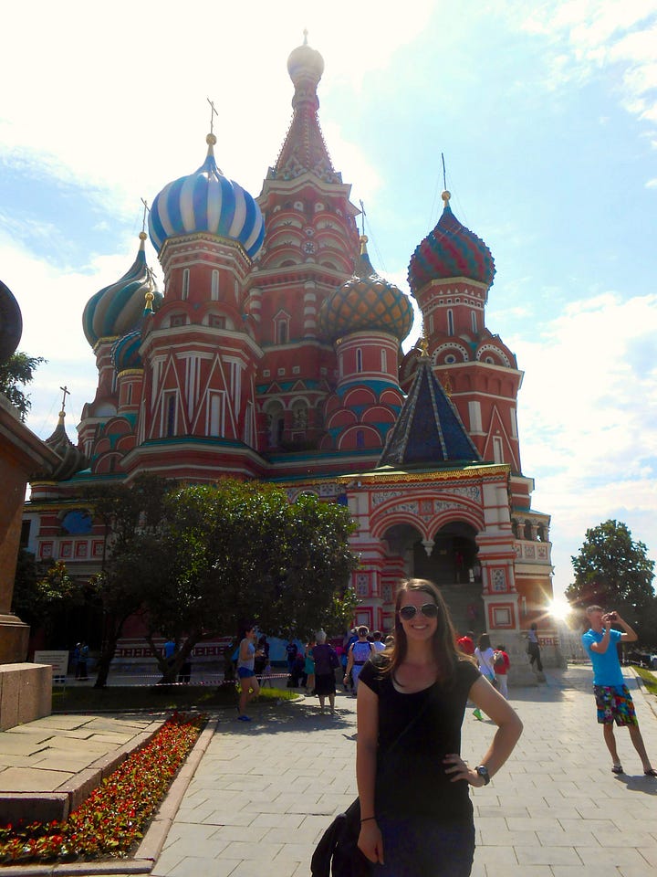 A travel collage: a woman poses in front of St. Basil's Cathedral in Moscow's Red Square (left), and smiles with the white-washed clifftop village of Santorini, Greece stretching behind her (right).
