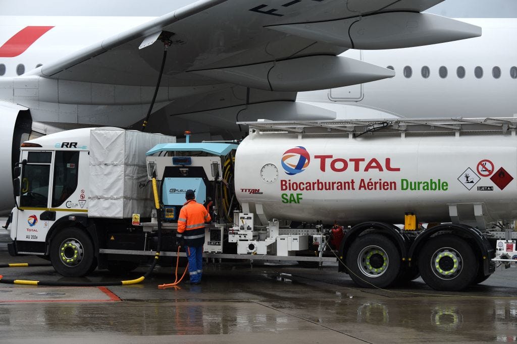 Staff members refuel an Airbus A350-900, the first Air France jet long-haul aircraft fuelled with sustainable aviation fuel produced by French energy group Total at Roissy airport on May 18, 2021.  (ERIC PIERMONT/AFP—Getty Images)