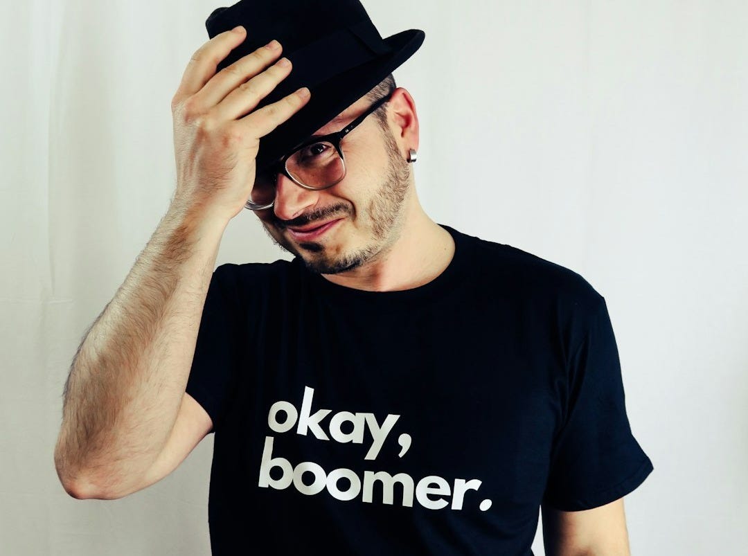 man in black crew neck t-shirt wearing black fedora hat