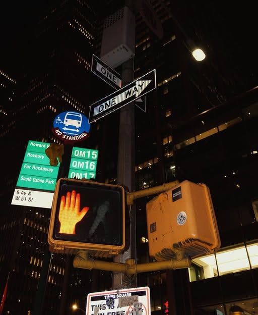 May be an image of skyscraper, street, Times Square and text