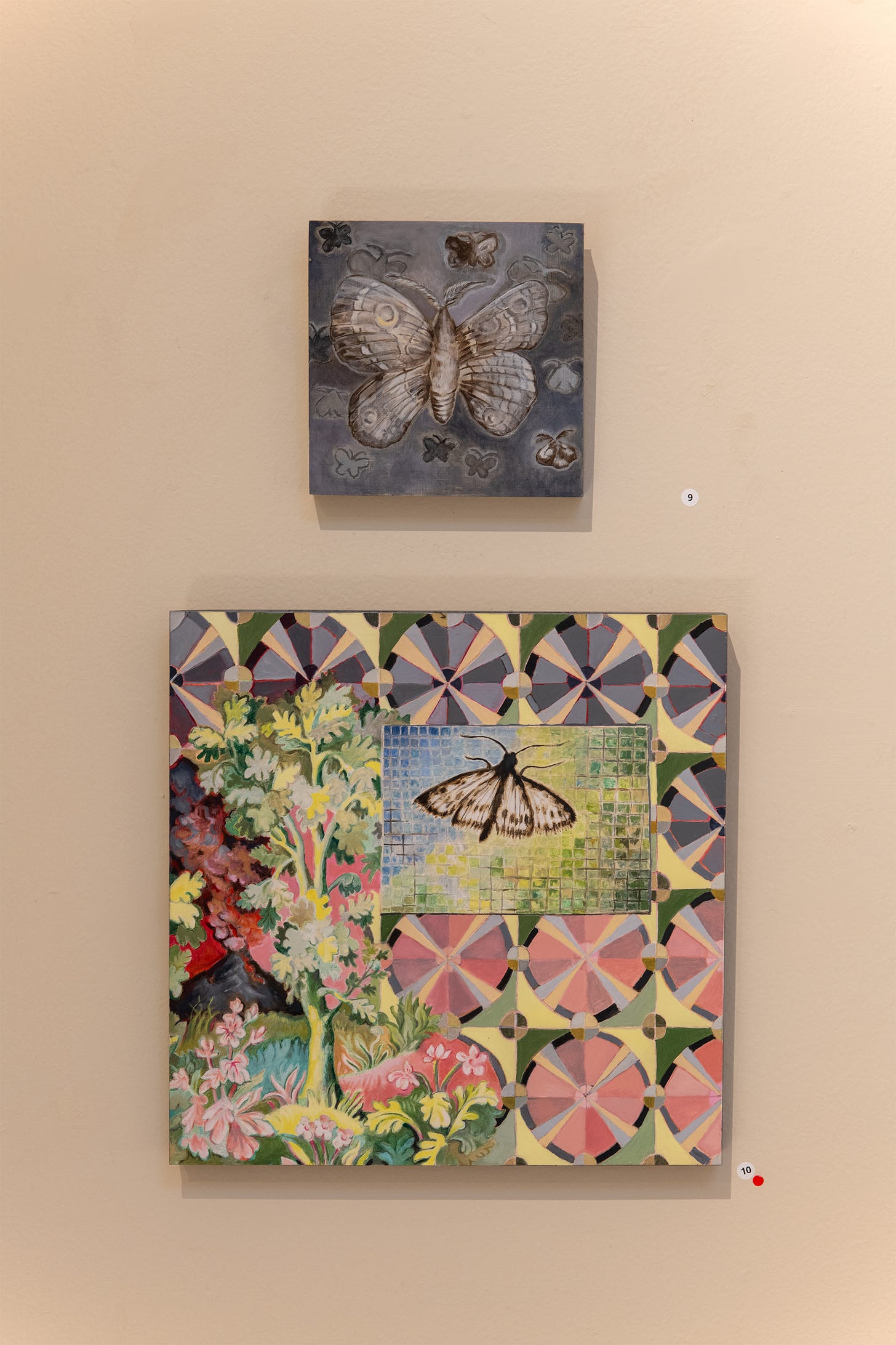 Two artworks on a wall, both created by Weinberg: the top is a small square painting depicting a large moth and then some smaller moths surrounding it, in Black and White, the bottom depicts a moth on a colorful tile floor which is surrounded by a surrealist landscape and elaborate pattern.