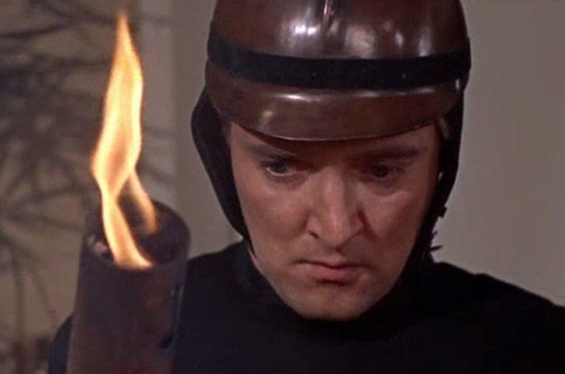 Still from Fahrenheit 451 showing a fireman preparing to burn books Still from Fahrenheit 451 showing a fireman preparing to burn books