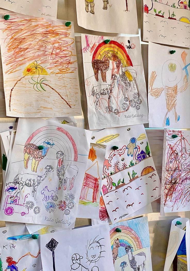 This may contain: children's drawings are hung up on the wall
