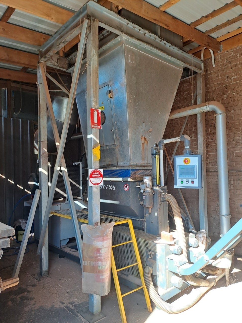 Collected sawdust fed into the press.