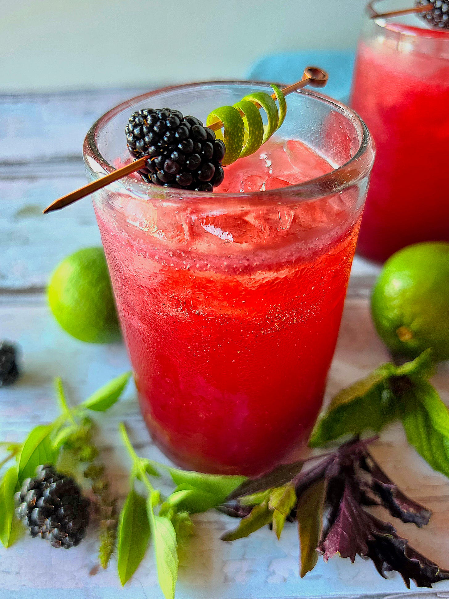 an angled view of a cocktail with another partial cocktail in the background