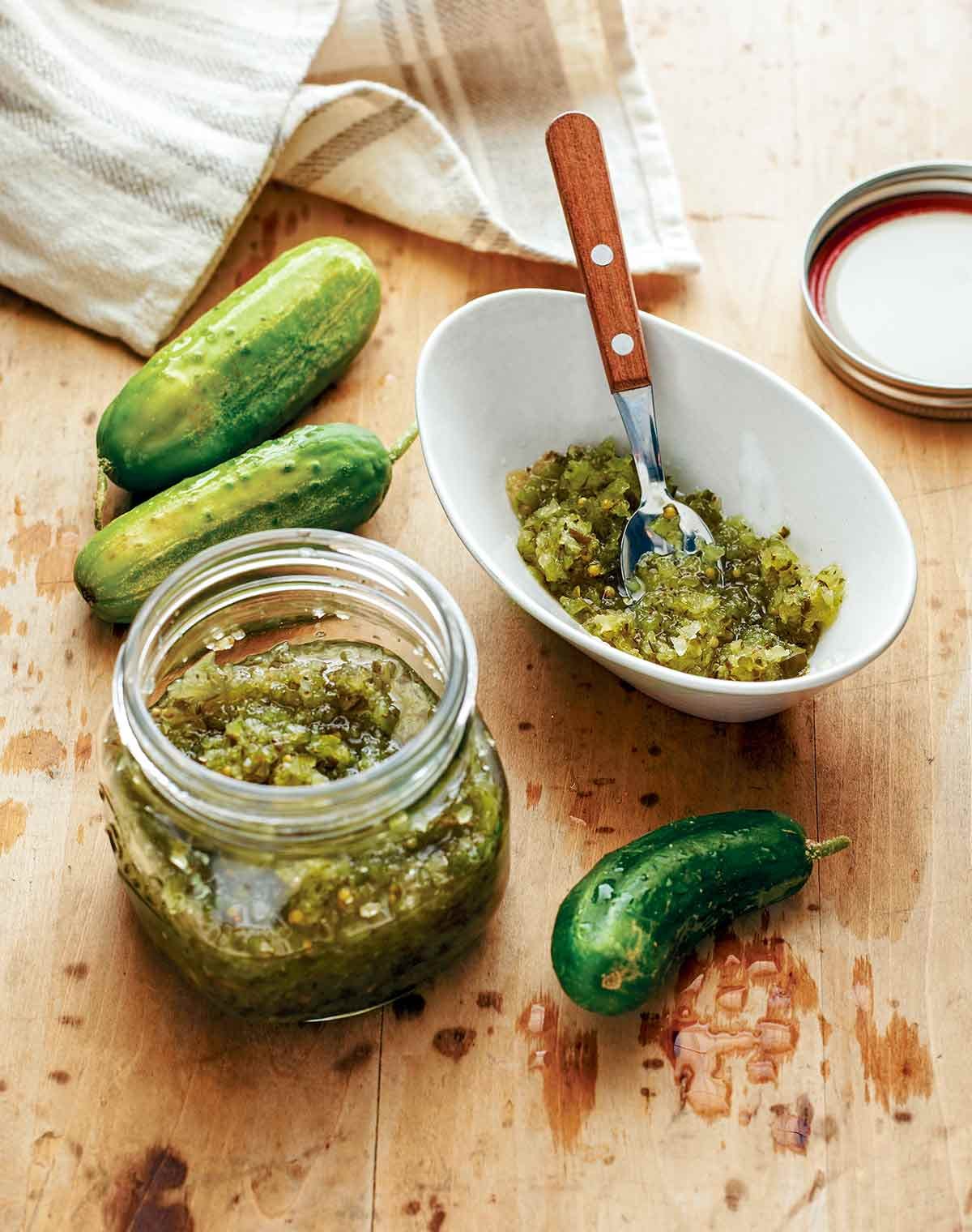 A glass jar filled with vibrant green homemade sweet pickle relish for cookouts.