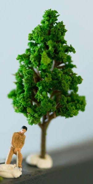 green tree and two men figurines