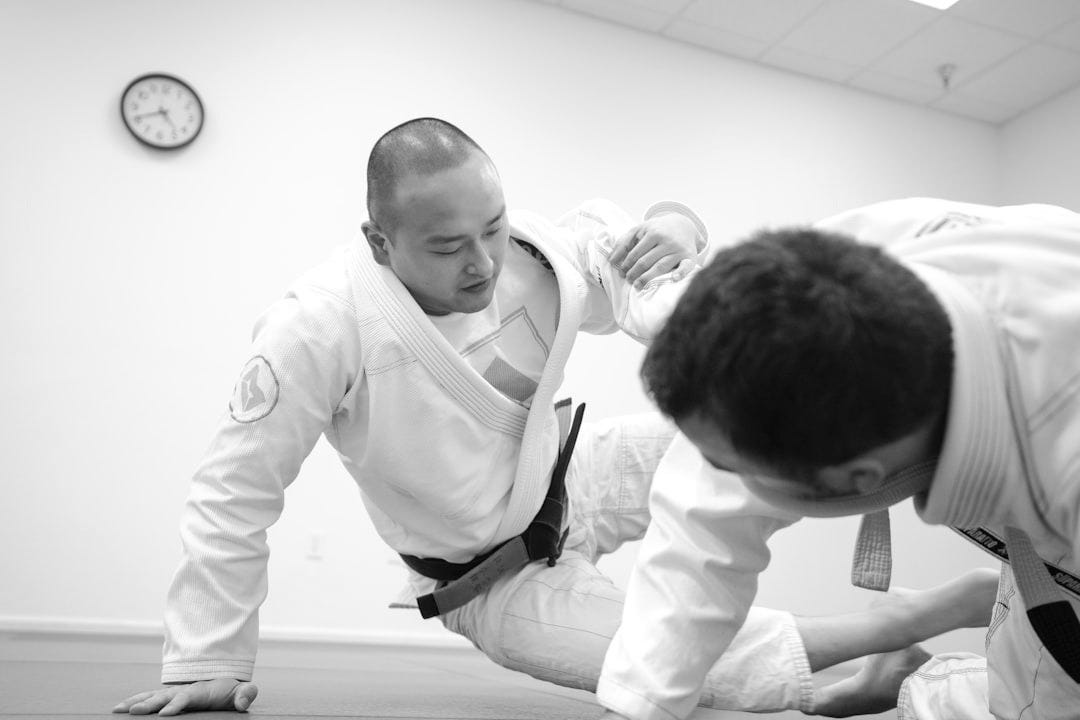 two men doing karate inside room two men doing karate inside room