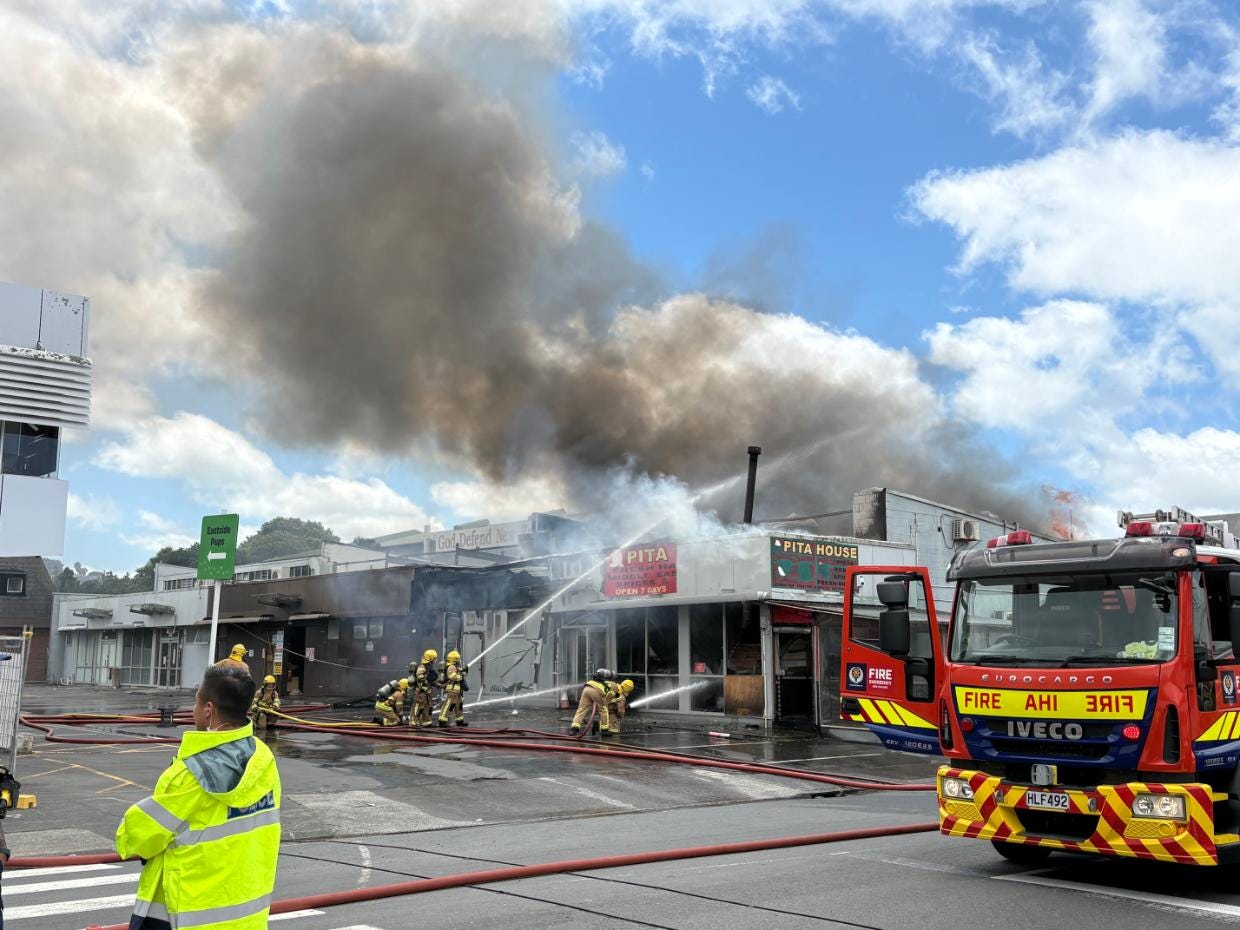 Firefighters battle the blaze at Pita House. 