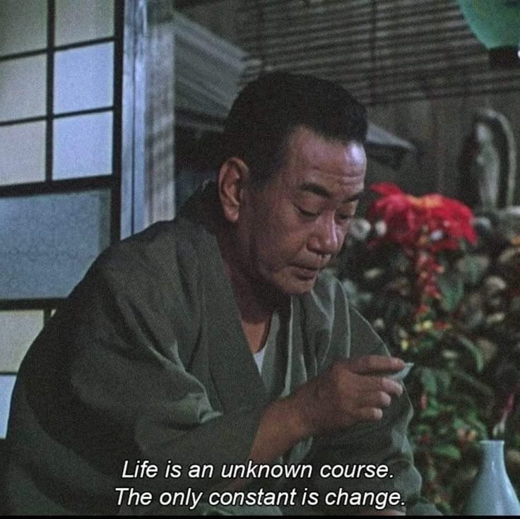 This may contain: the man is looking at his cell phone