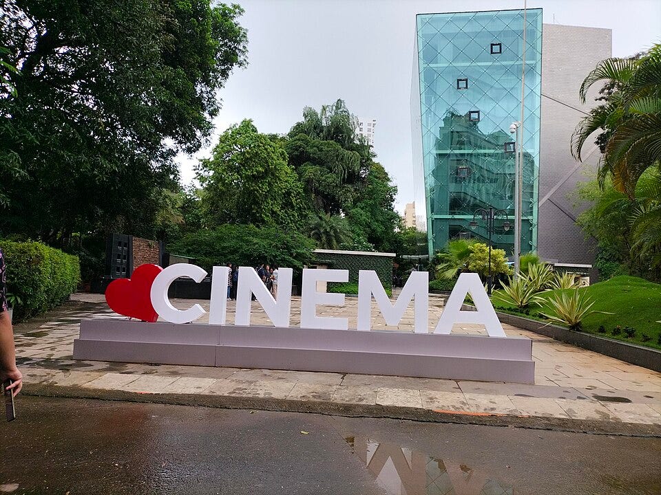 a sign with a heart and the world CINEMA in bold white letters a sign with a heart and the world CINEMA in bold white letters