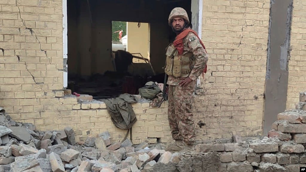 A Pakistani soldier examines the site of a suicide bombing in Dera Ismail Khan that killed nearly two dozen people on December 12. 