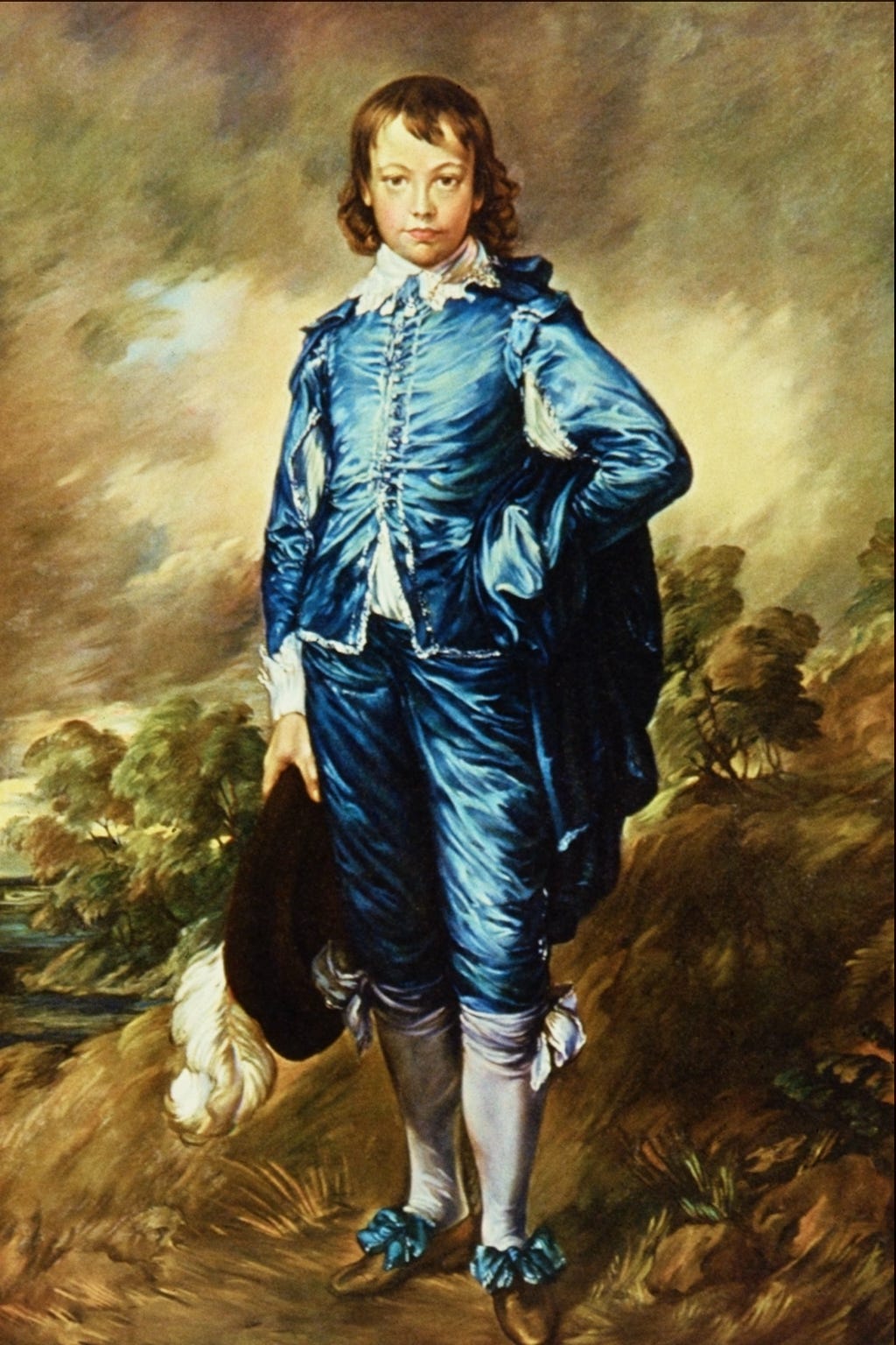 A boy in a shining blue satin costume stands confidently in a dark landscape A boy in a shining blue satin costume stands confidently in a dark landscape