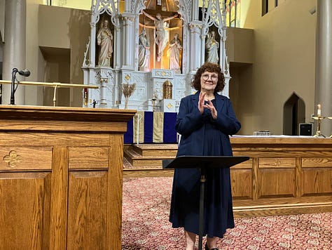 Three photos are shown, are all of white individuals in a church sanctuary with a white altar and a large cross behind them. The first image at left shows a white woman in a navy blue dress with curly auburn hair. She is using sign language. She’s wearing glasses. In the next image a man with white hair and a light grey button-down dress shirt. He’s also speaking in sign language next to a woman at a podium making an announcement. She has long brown hair. Both are wearing glasses. At the right are two women singing in sign language, one on the left has short blond hair and is wearing a purple sweatshirt, the other is wearing a dark colored dress and has curly brown hair. 