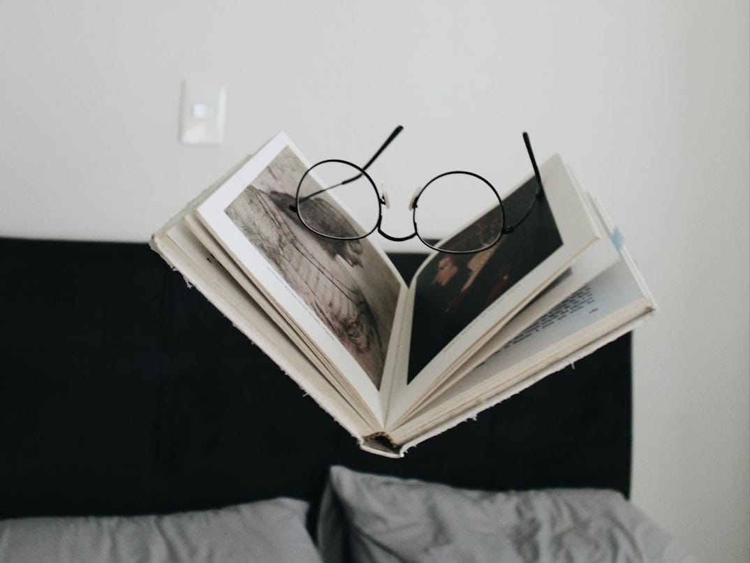 black framed eyeglasses between opened book black framed eyeglasses between opened book