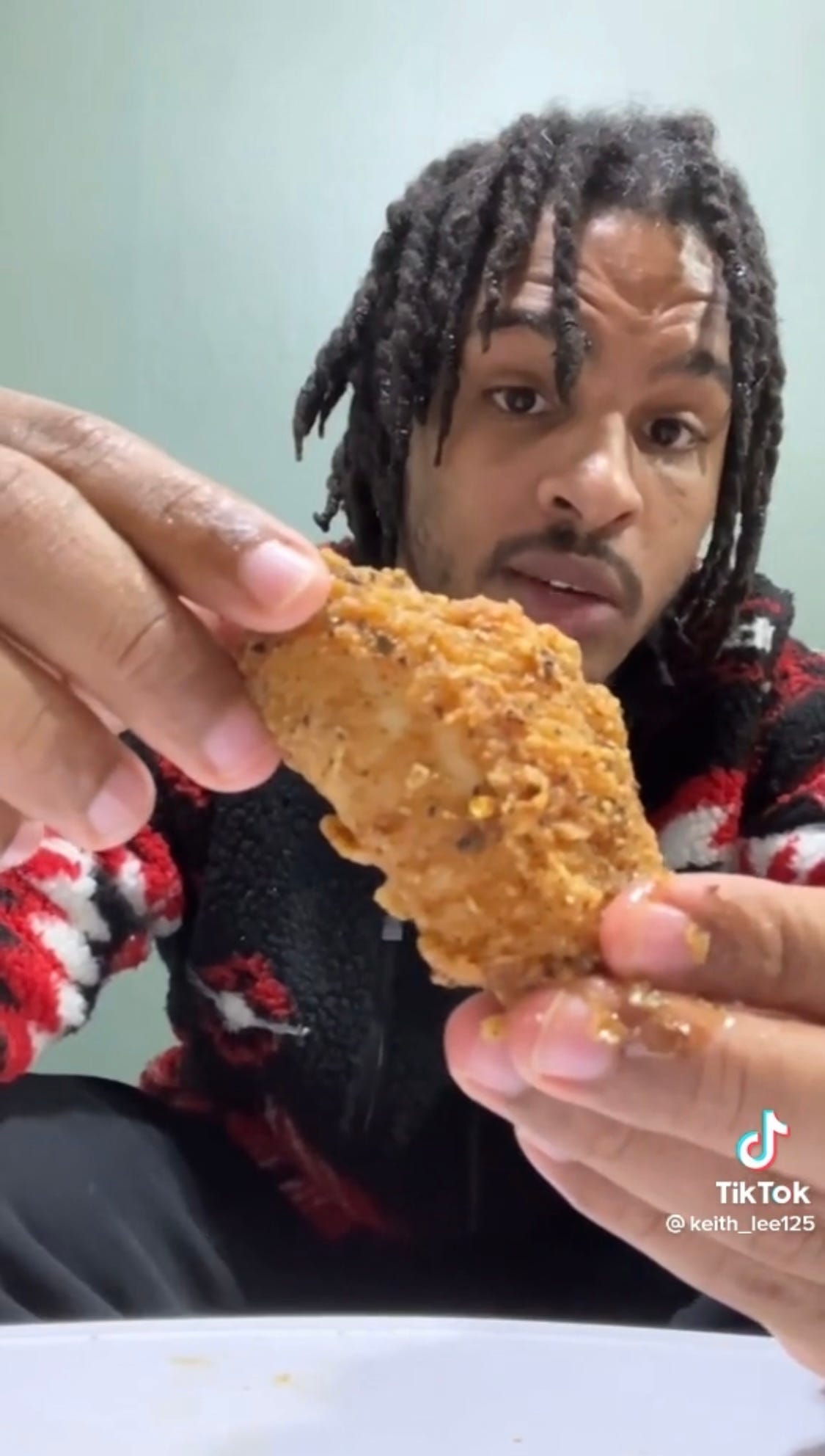 TikToker Keith Lee giving his trademark food reviews on video