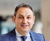 Murat Dizdar PSM, Secretary of the NSW Department of Education in a blue suit.