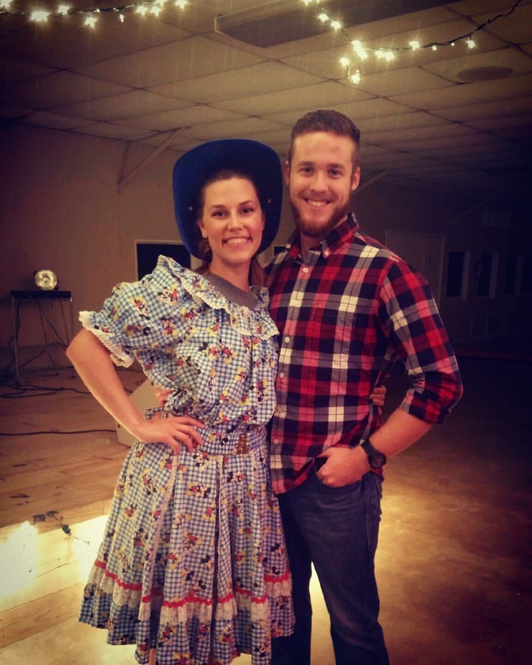 Sarah and her husband, Steven, at a church camp. Sarah is wearing a ridiculous square dancing costume.