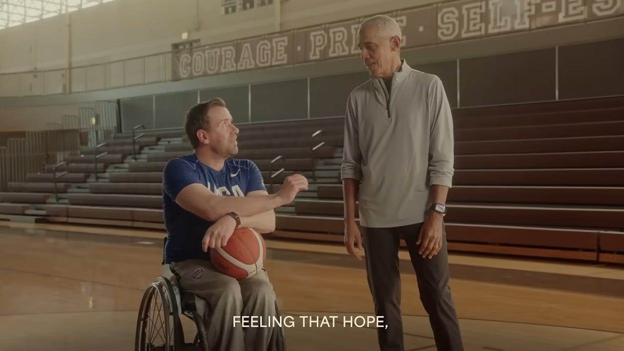Video screenshot: In a (high school?) gym with wooden bleachers, Senate candidate Josh Turek, seated in a wheelchair, holding a basketball, and wearing a Team USA jersey, speaks to Barack Obama, who wears a brown and tan warmup outfit. Caption reads 'feeling that hope.' (full sentence was 'Ill tell you what, people all across Iowa are saying that they're feeling that hope, that optimism, for the first time in a long time.' Video screenshot: In a (high school?) gym with wooden bleachers, Senate candidate Josh Turek, seated in a wheelchair, holding a basketball, and wearing a Team USA jersey, speaks to Barack Obama, who wears a brown and tan warmup outfit. Caption reads 'feeling that hope.' (full sentence was 'Ill tell you what, people all across Iowa are saying that they're feeling that hope, that optimism, for the first time in a long time.'