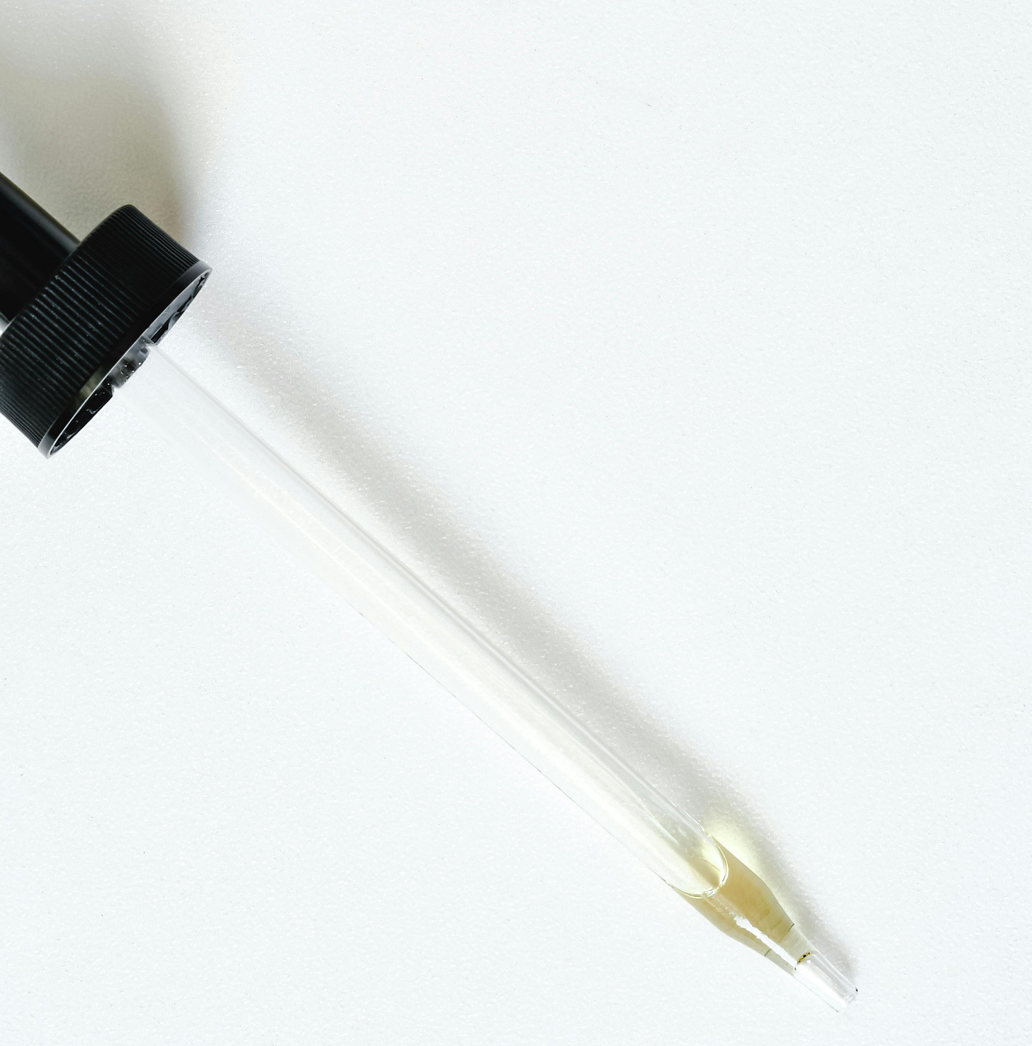 A pipette with a tiny bit of liquid left in the tip.
