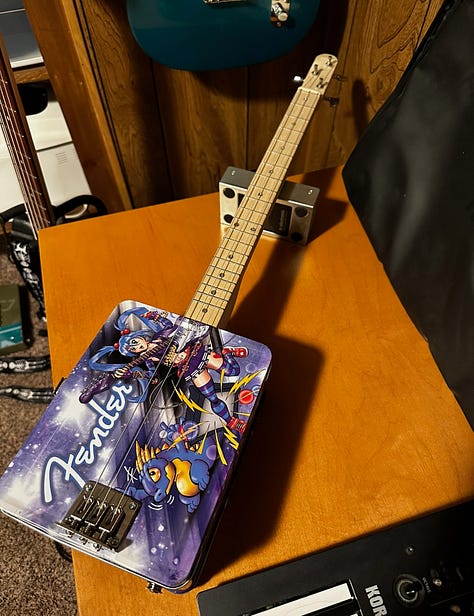 A guitar made out of a lunchbox and a broken guitar neck, a bass made out of a surplus military box, and a drum set made out of, basically, trash