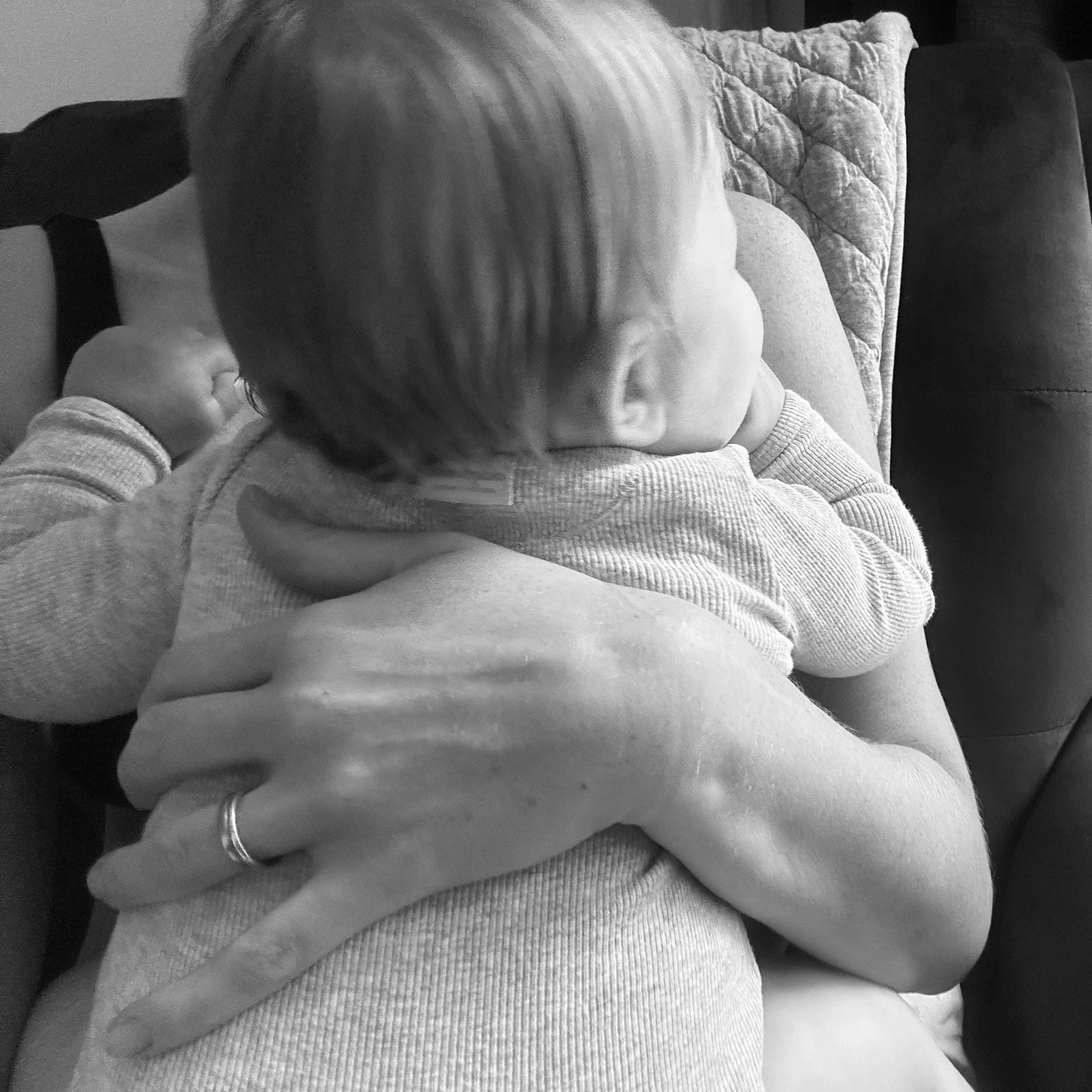 A mother holding her baby to her chest