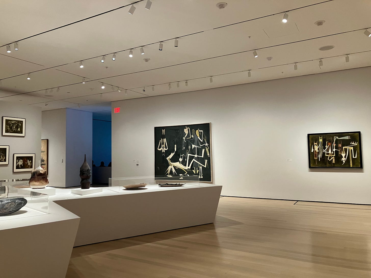 installation view of black and white angular paintings and ceramics on display installation view of black and white angular paintings and ceramics on display