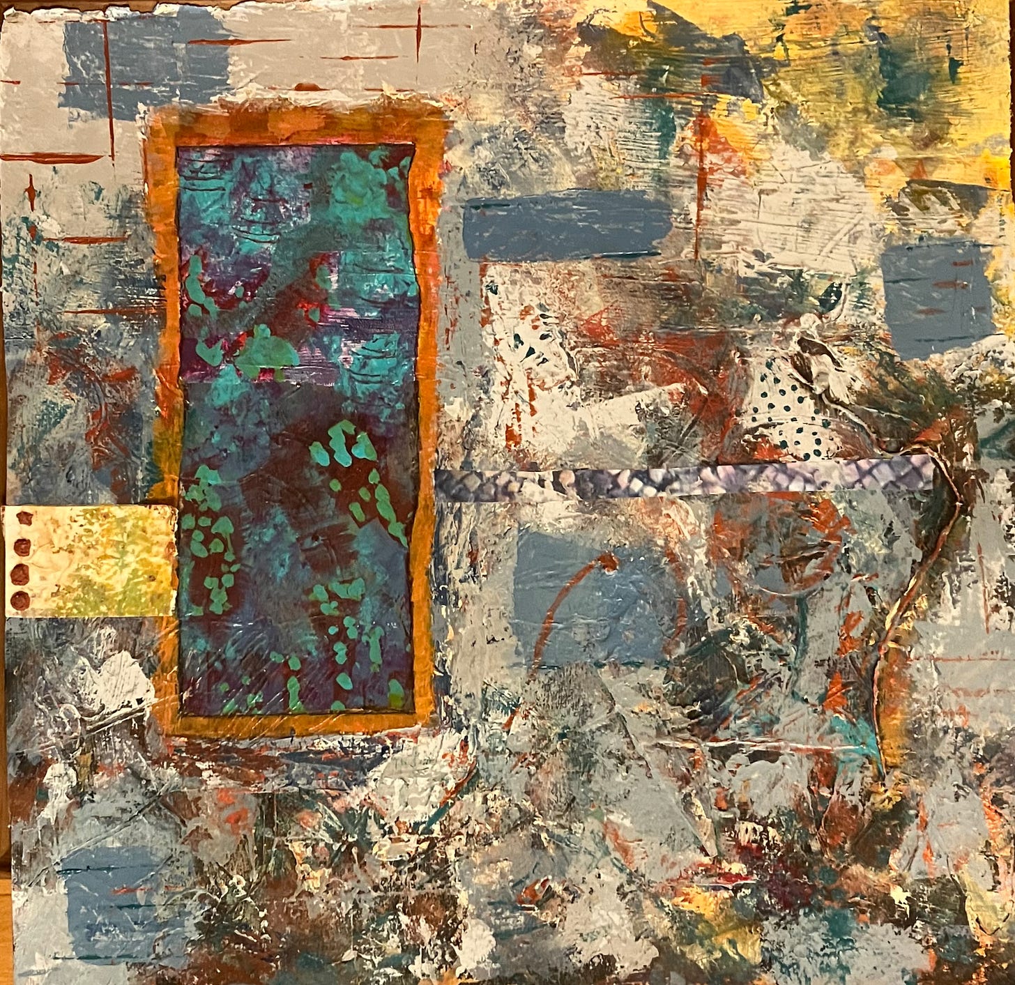 A piece of mixed media art primarily in blues, beige and yellow with some orange. The focal point is a turquoise rectangle ring and orange with an impression of flowers.