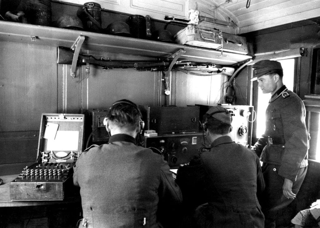 Picture of German soldiers using a radio and an Enigma Machine