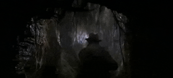 Indiana Jones running from a boulder rolling after him