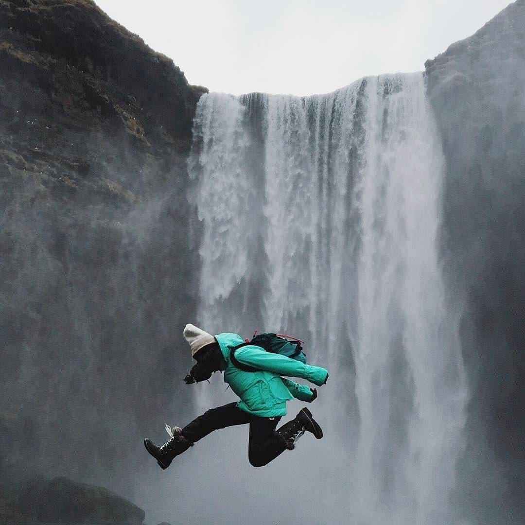 women jumping over a cliff