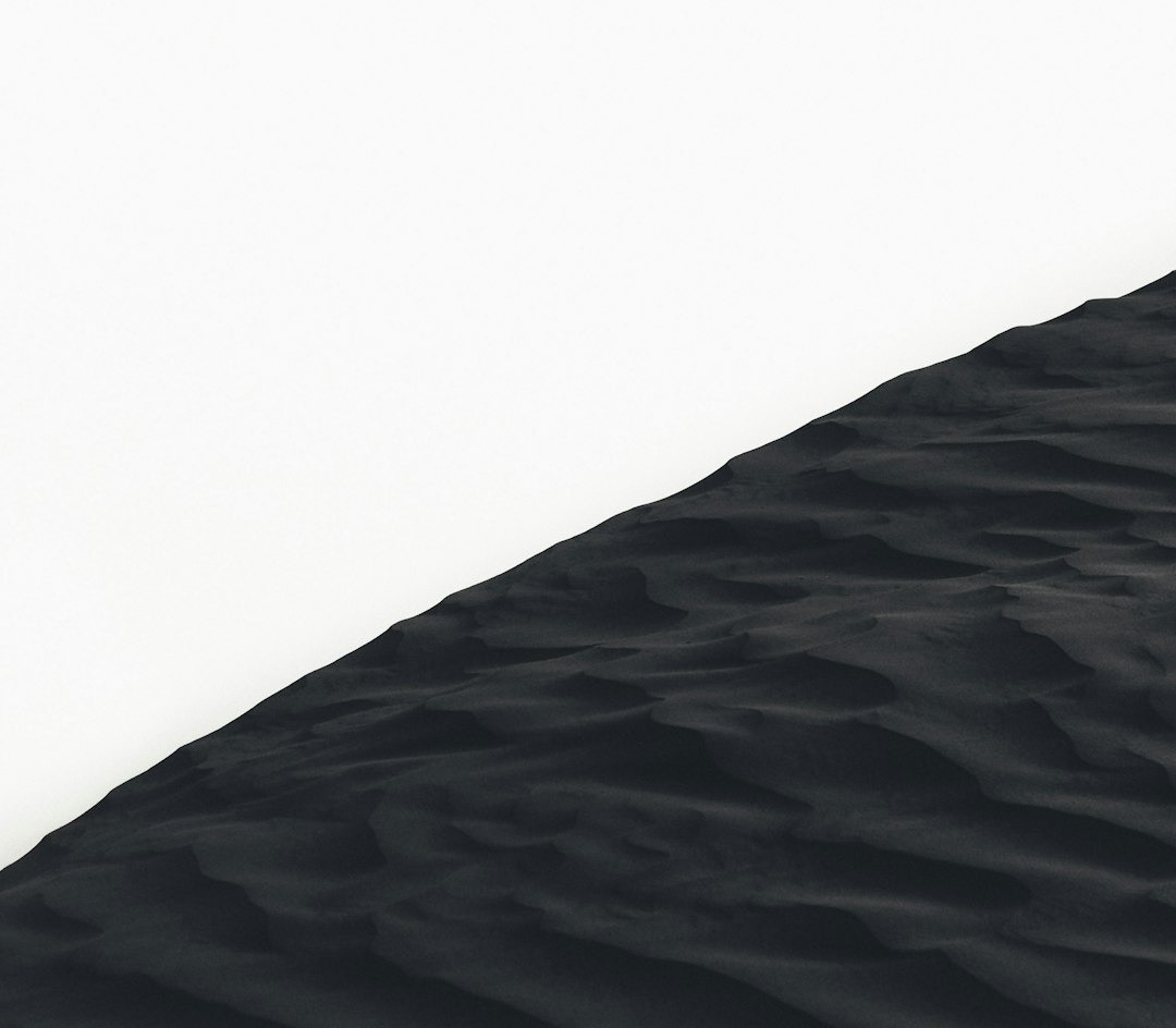 grayscale photo of sand dunes