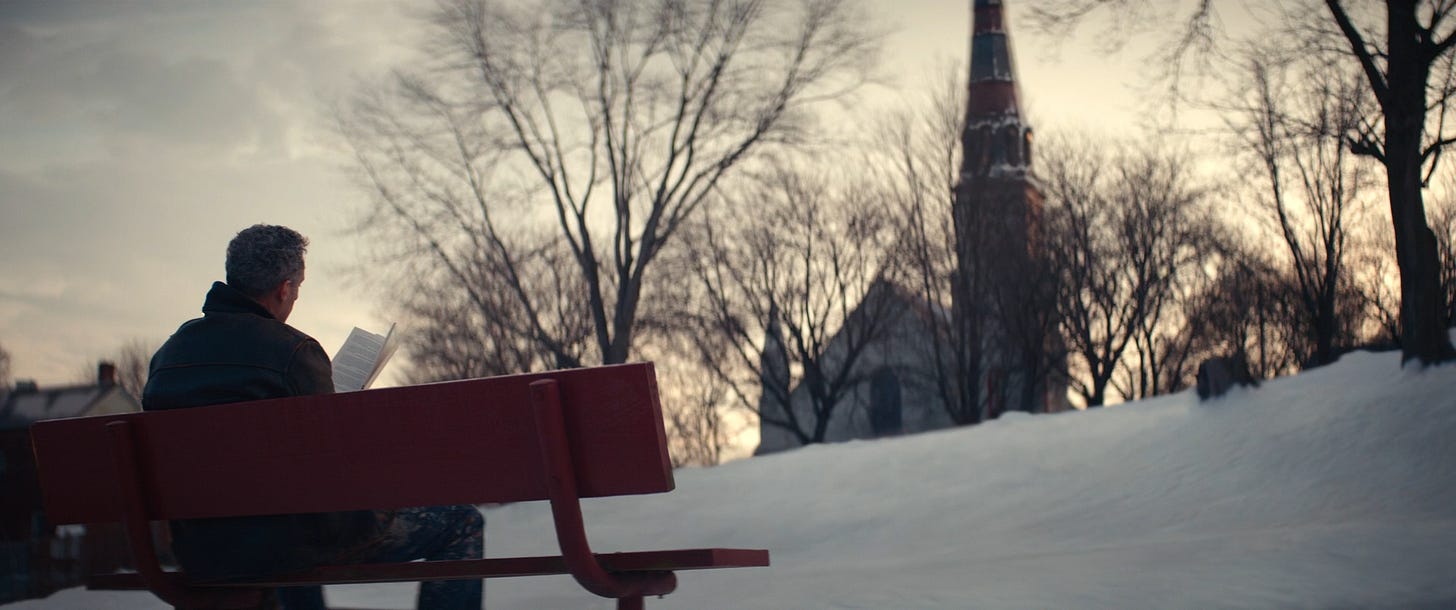 Outie Irving reading on a bench