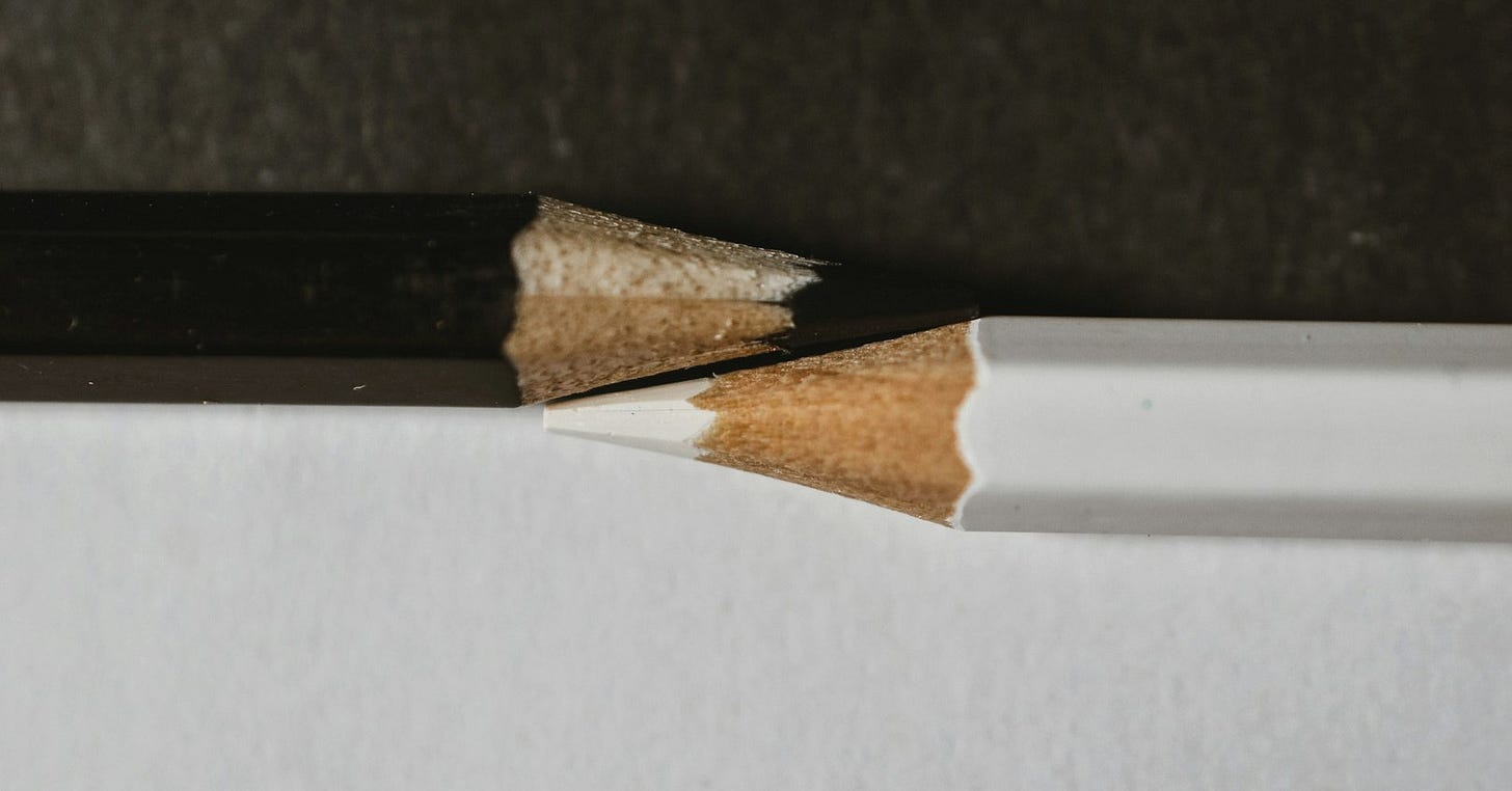 a pencil sticking out of the side of a white wall