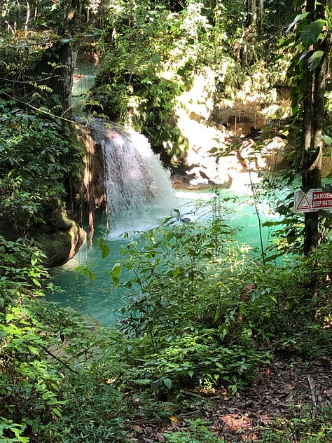 ladies outside an old jamaican house, a waterfall, a beach