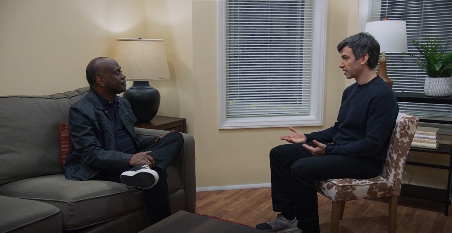 Nathan Fielder and Kor Skeet's replica actor in a replica of Skeet's living room