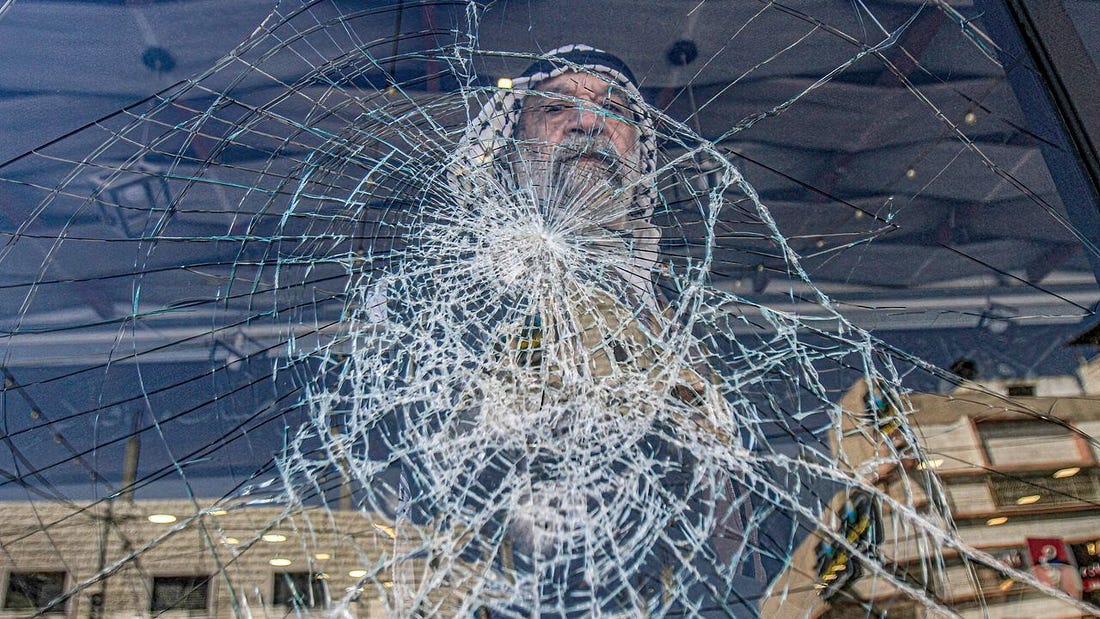 A Palestinian inspects the damage to his restaurant as a result of the attack by Jewish settlers, in the town of Hawara, south of Nablus in the occupied West Bank