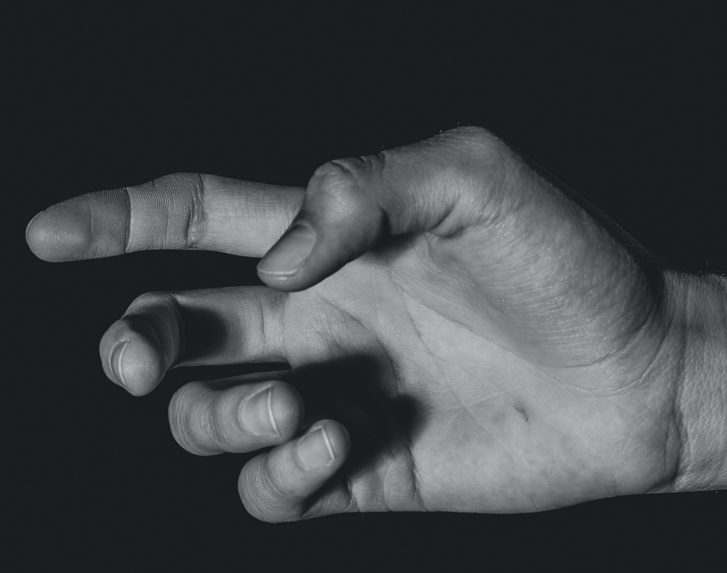hand in darkness reaching left hand in darkness reaching left