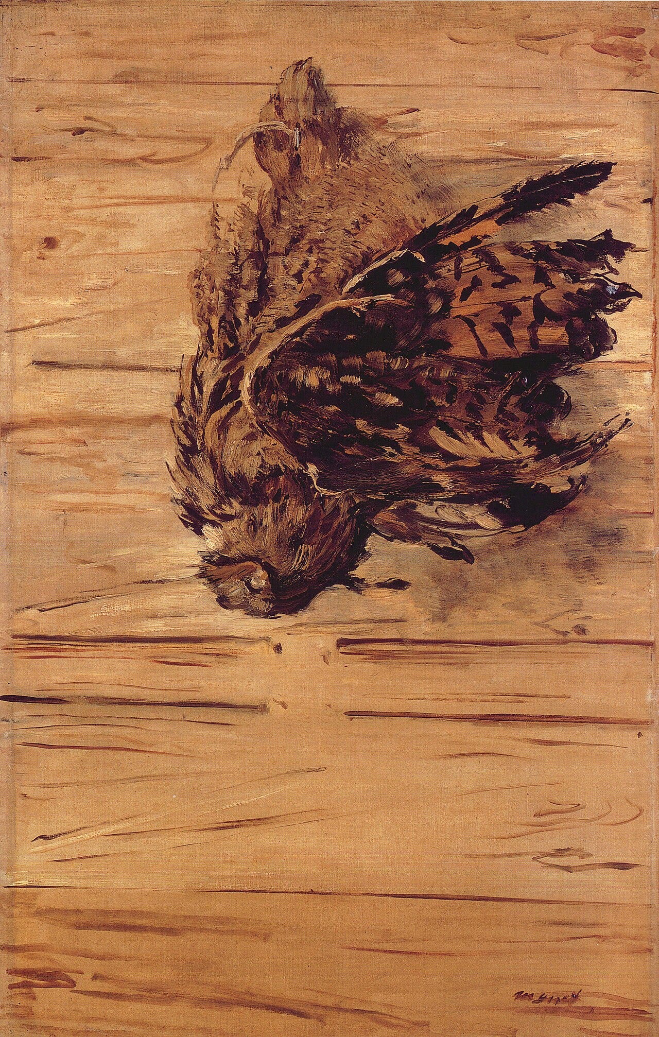 A dead eagle owl hanging upside down from a nail A dead eagle owl hanging upside down from a nail