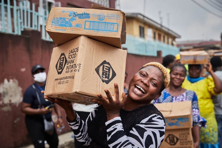 A woman smiles during a Lagos Food Bank drive. Credit: The Lagos Food Bank A woman smiles during a Lagos Food Bank drive. Credit: The Lagos Food Bank