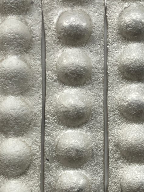 silver textured with stones and press formed to resemble pearls