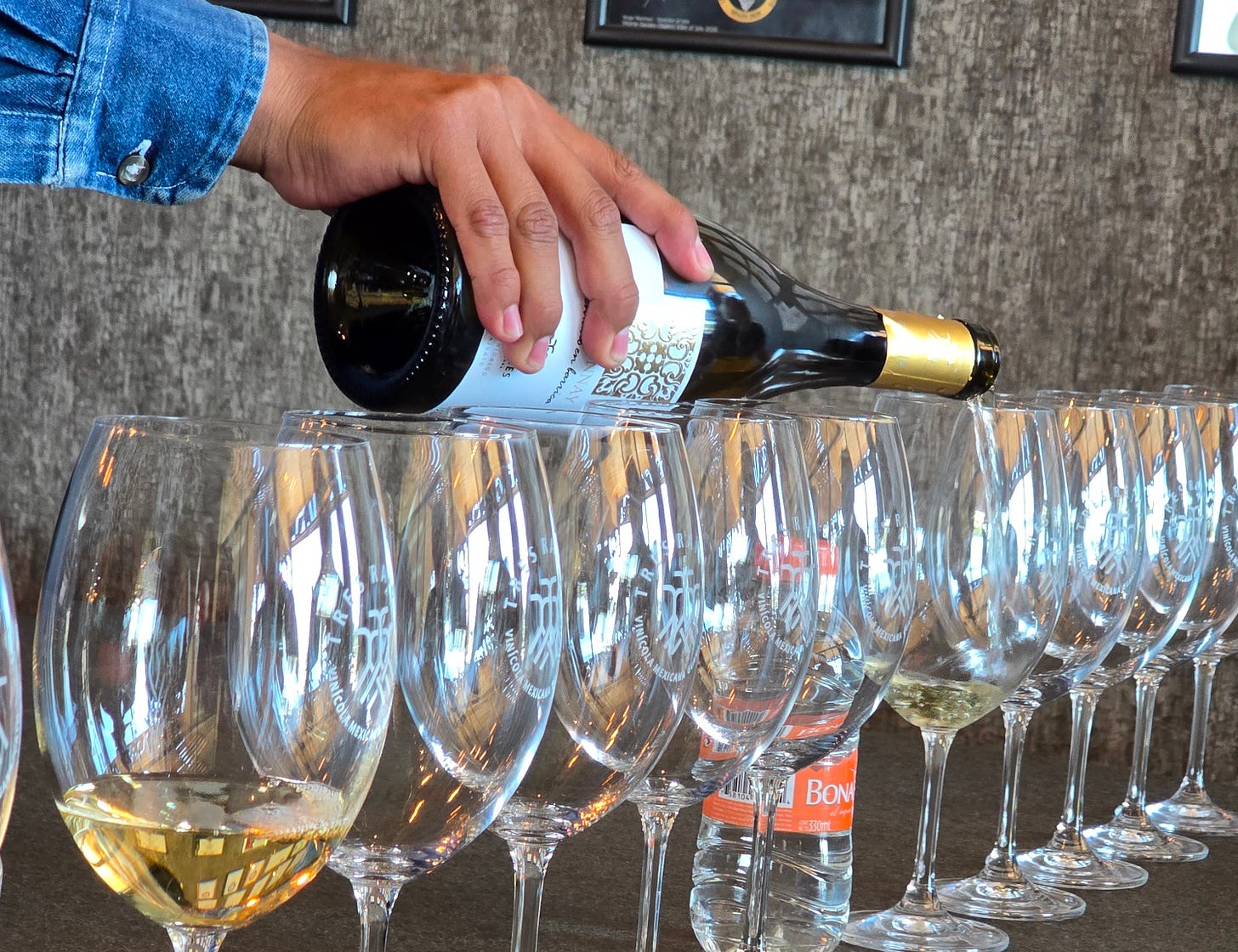 wine glasses being filled for a wine tasting