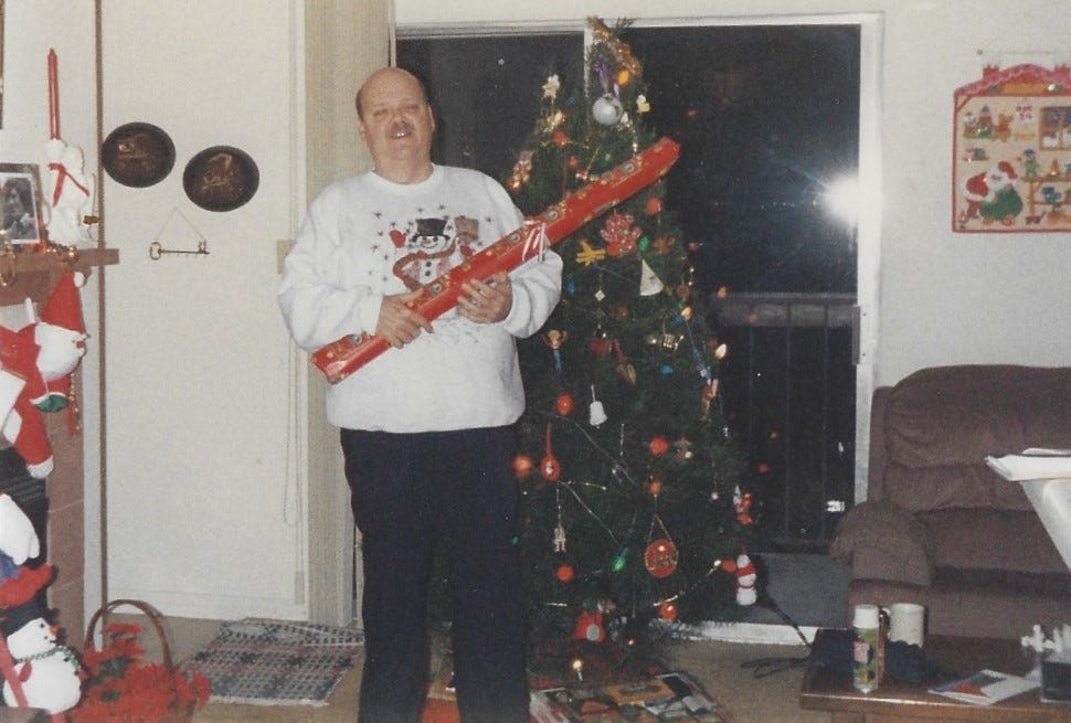 Dad in front of our Christmas tree in 1992.