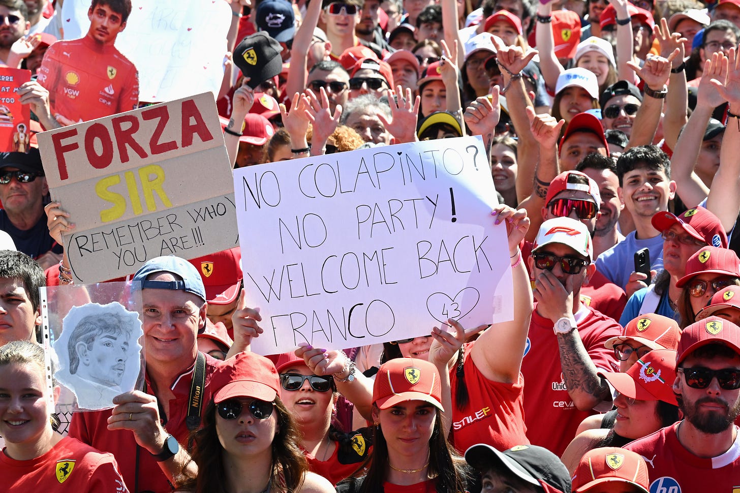 A fan holds a sign which reads: 'No Colapinto, no party, welcome back Franco'. A fan holds a sign which reads: 'No Colapinto, no party, welcome back Franco'.