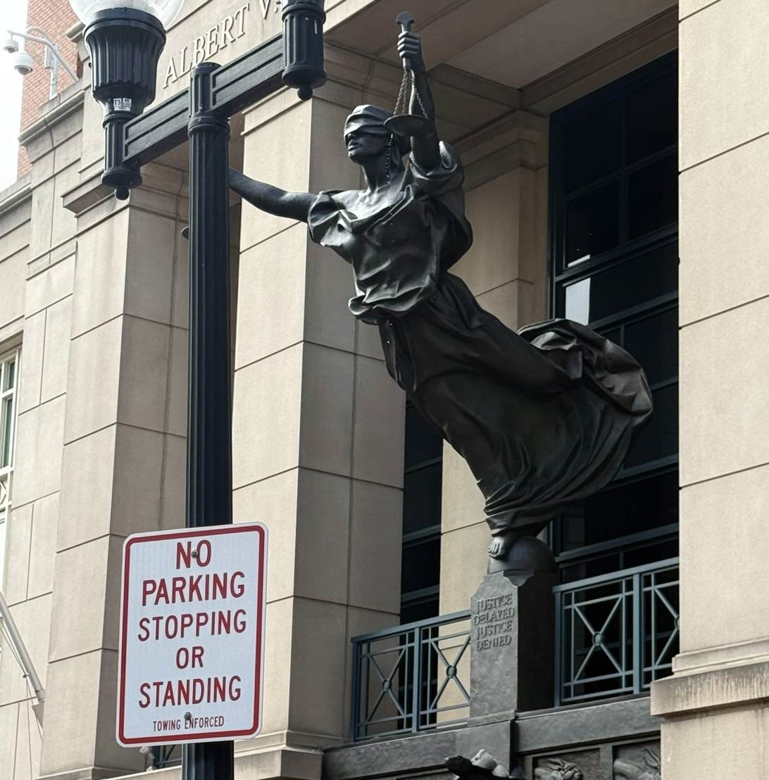A statue of a person from a pole

AI-generated content may be incorrect.