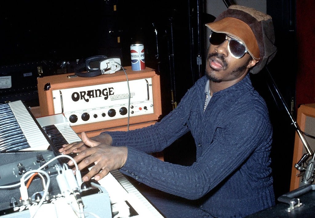 Stevie Wonder sat at a keyboard in 1973